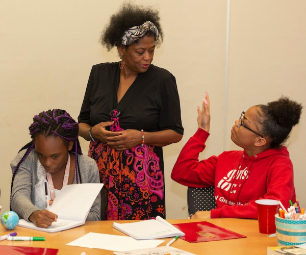 Madison poet Fabu interacts with Odyssey Junior participants Angel, left, and Rahqayyah, right, during a visit to the program.