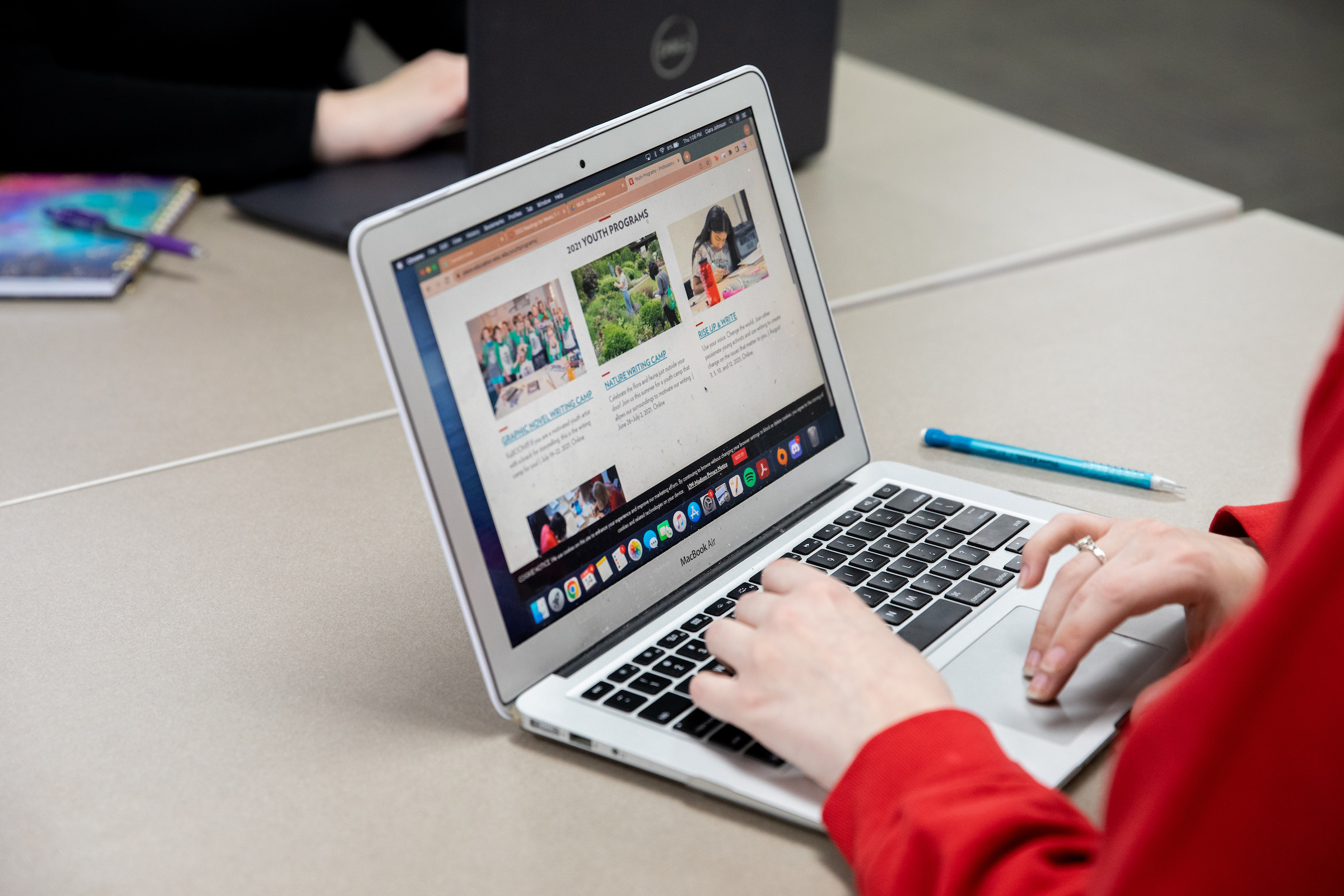 A person types on a laptop.
