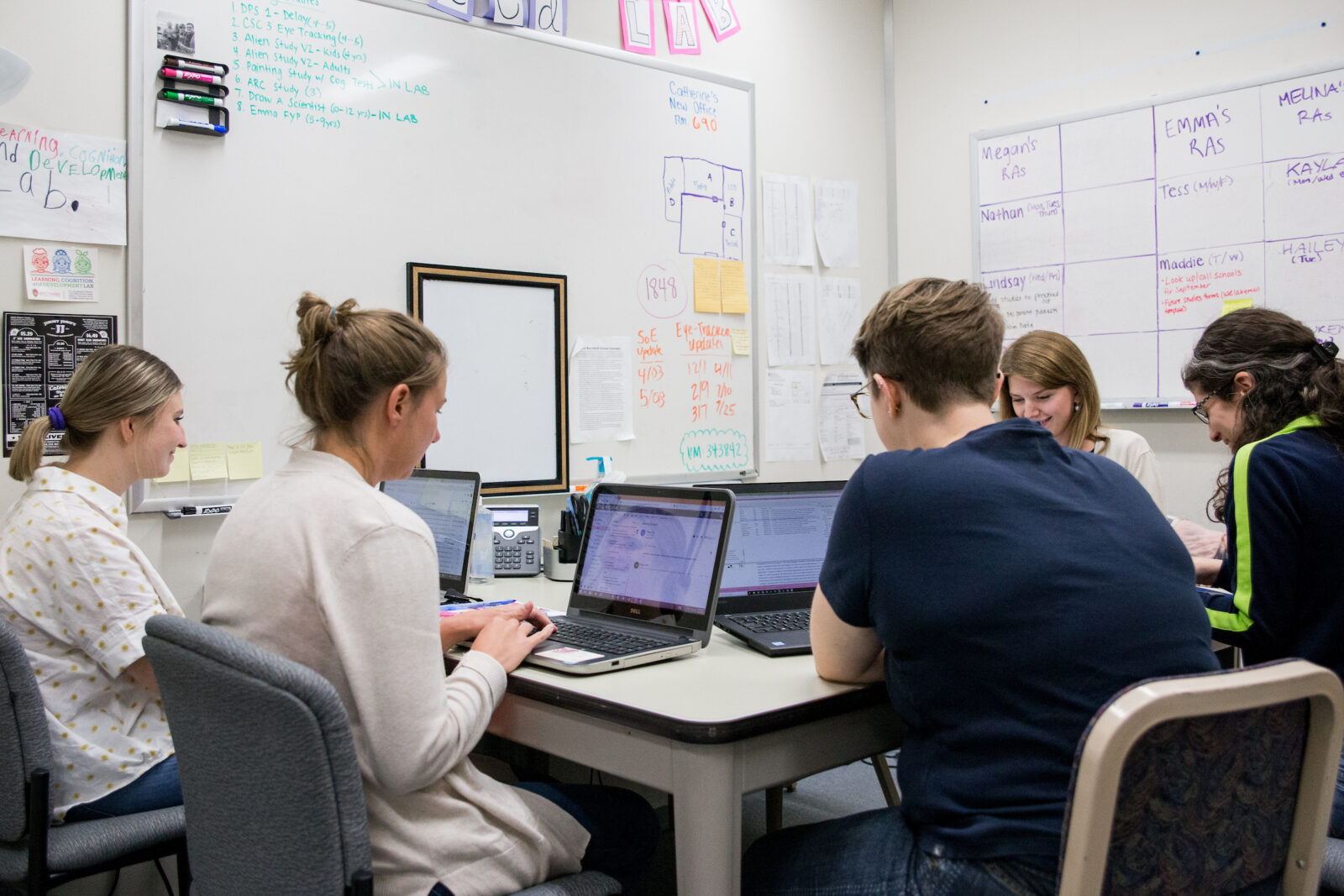 A group of researchers work at laptops